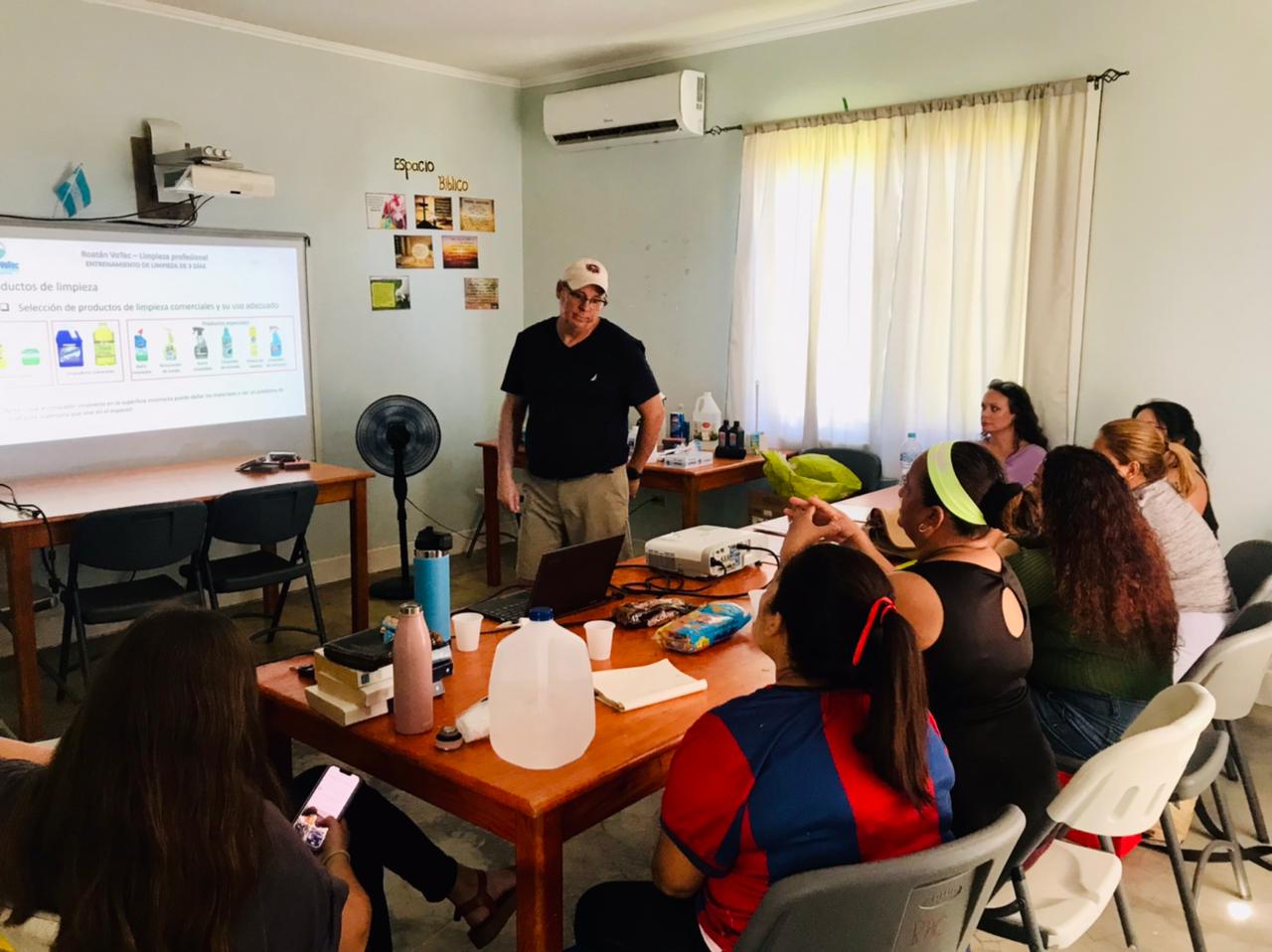 Housekeeping students in a projector-based classroom training session at RVT